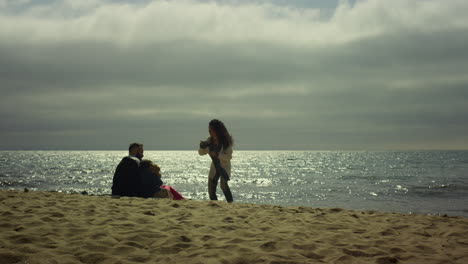 Verspielte-Familie-Hat-Spaß-Am-Urlaubsstrand-Am-Meer.-Glückliche-Menschen,-Die-Draußen-Fotos-Machen