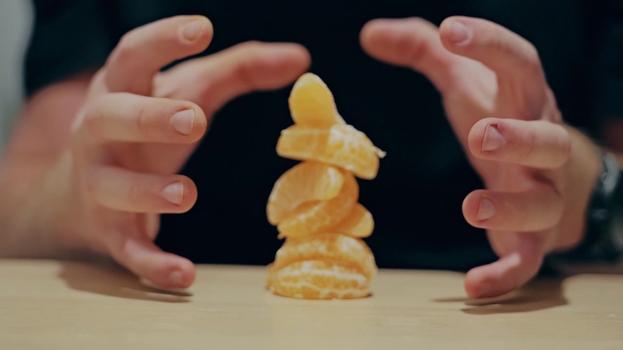 Slow motion hands create calming mindfulness metaphor with fresh citrus segments