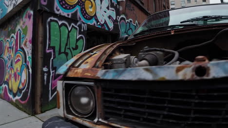 graffiti-covered alley and rusty car