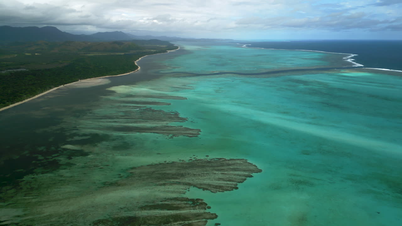 Wide aerial over lagoon off Po&eacute; Beach towards Shark Fault, western New Caledonia