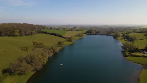 4k flying over hawkridge reservoir, drone raising over the water revealing the fishing boats docks and the water dam wall, 60fps