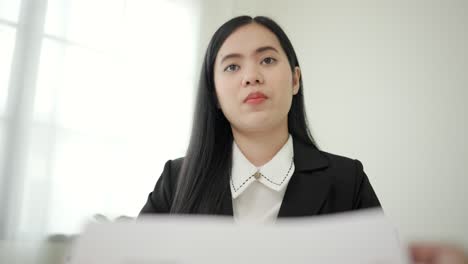 smart asian woman to greet a hr staff before a job interview to apply for a job. happy woman seeker or insurance broker presenting a business deal. business woman sending resume.