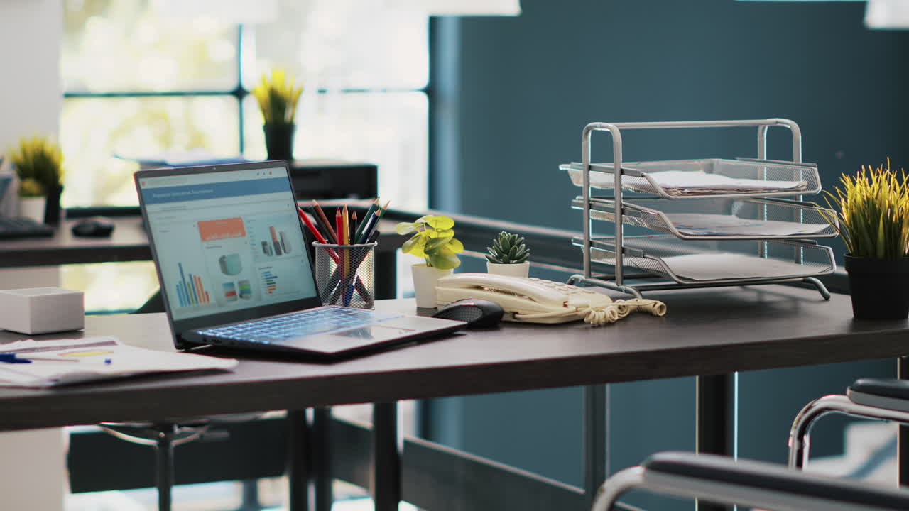 Documents on laptop screen in office containing business financial information