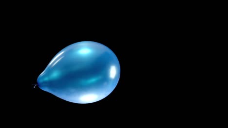 a radiant blue balloon falls gently, catching the light as it descends. positioned in the center of the display, it creates a captivating focal point, drawing attention with its smooth, graceful fall.