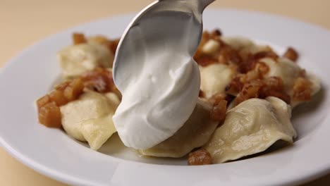 pierogi with sour cream and crispy onions