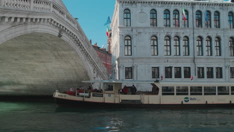 venice canal with bridge and water bus