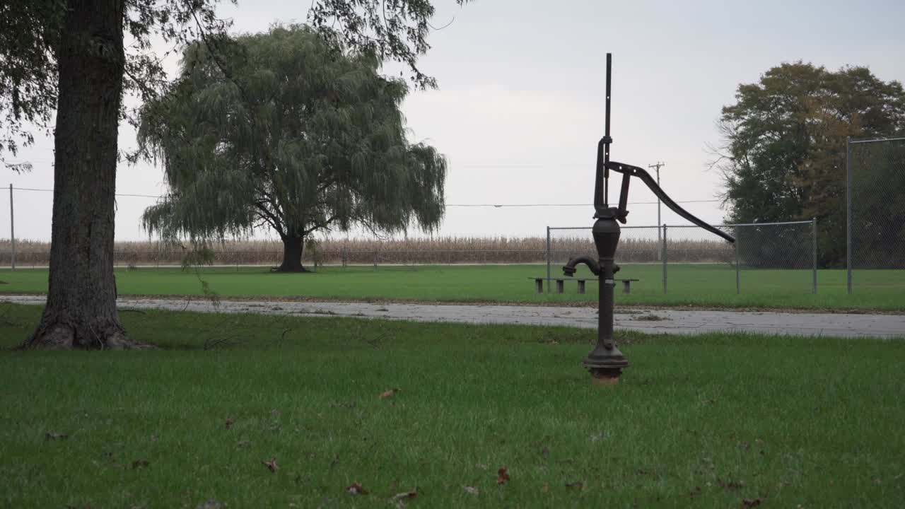 Old metal water pump on an overcast evening before dusk at Seims Park in Union, IL