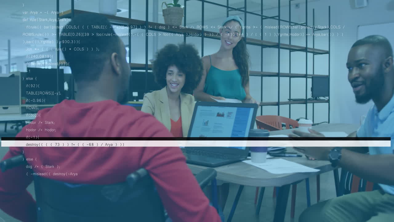 team collaborating around office table, pointing at laptop, displaying motion business charts