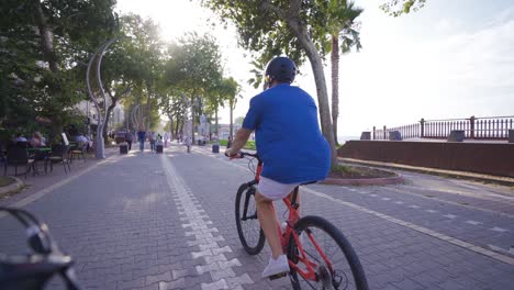 young man cycling on busy street.