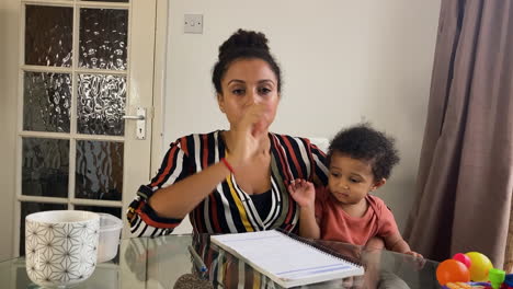 young woman with small child on business video call waiting for meeting to begin