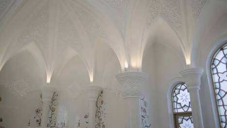 white palace interior with detailed ceiling and windows