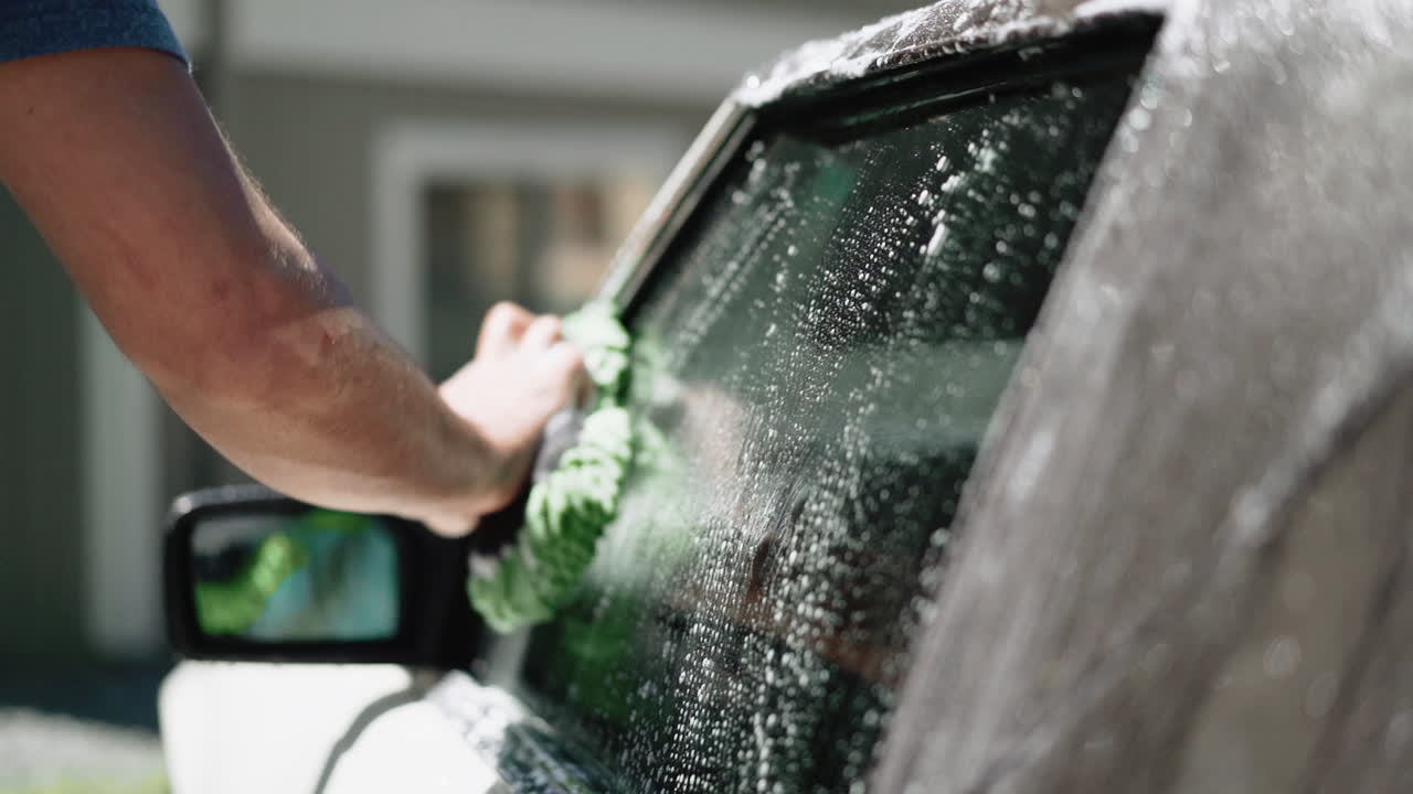 Man Washing Car Window
