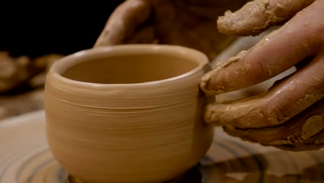 potter is making clay pot on the potter's wheel