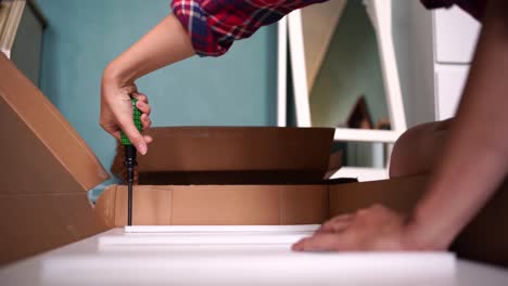 crop woman assembling furniture alone at home