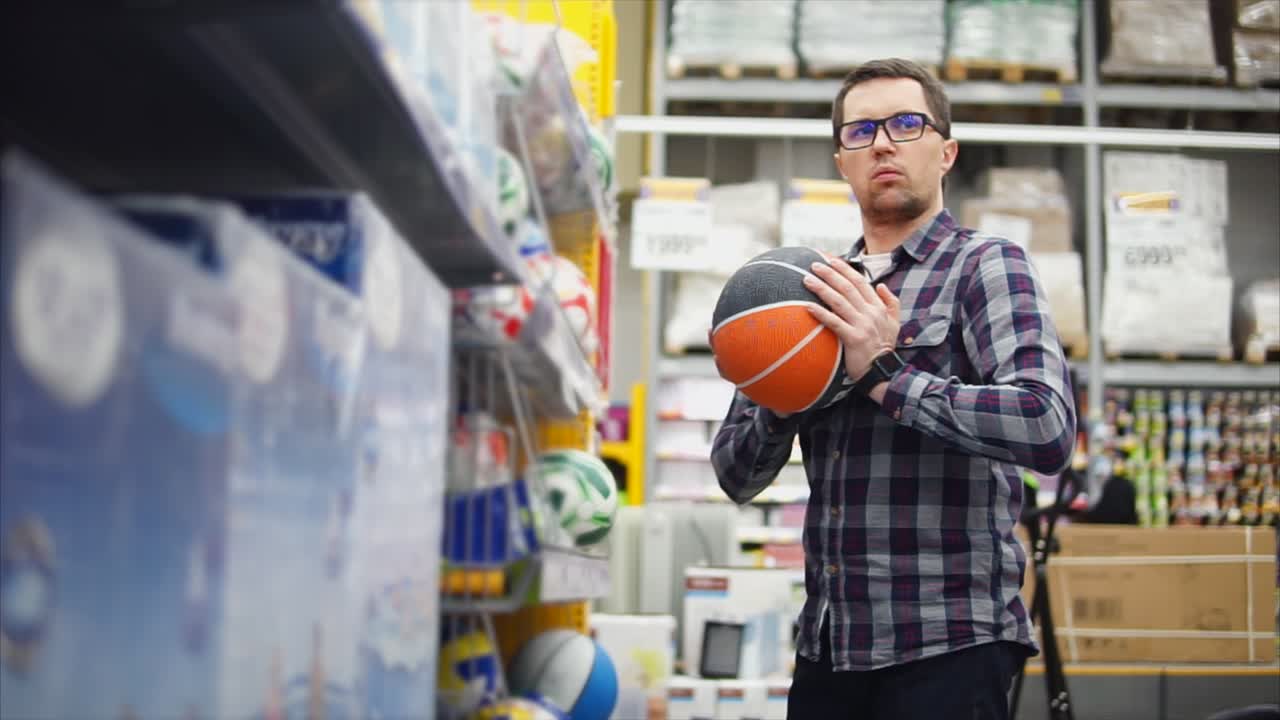 hombre comprando baloncesto en una tienda de deportes