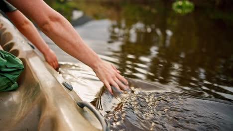 Hands,-kayak-and-palm-in-lake-water-on-vacation