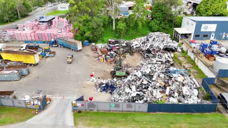 scrapyard operations with machinery and metal piles