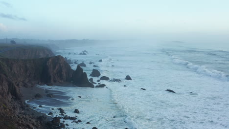 white ocean waves breaking along the rugged cliffs of bodega bay, california