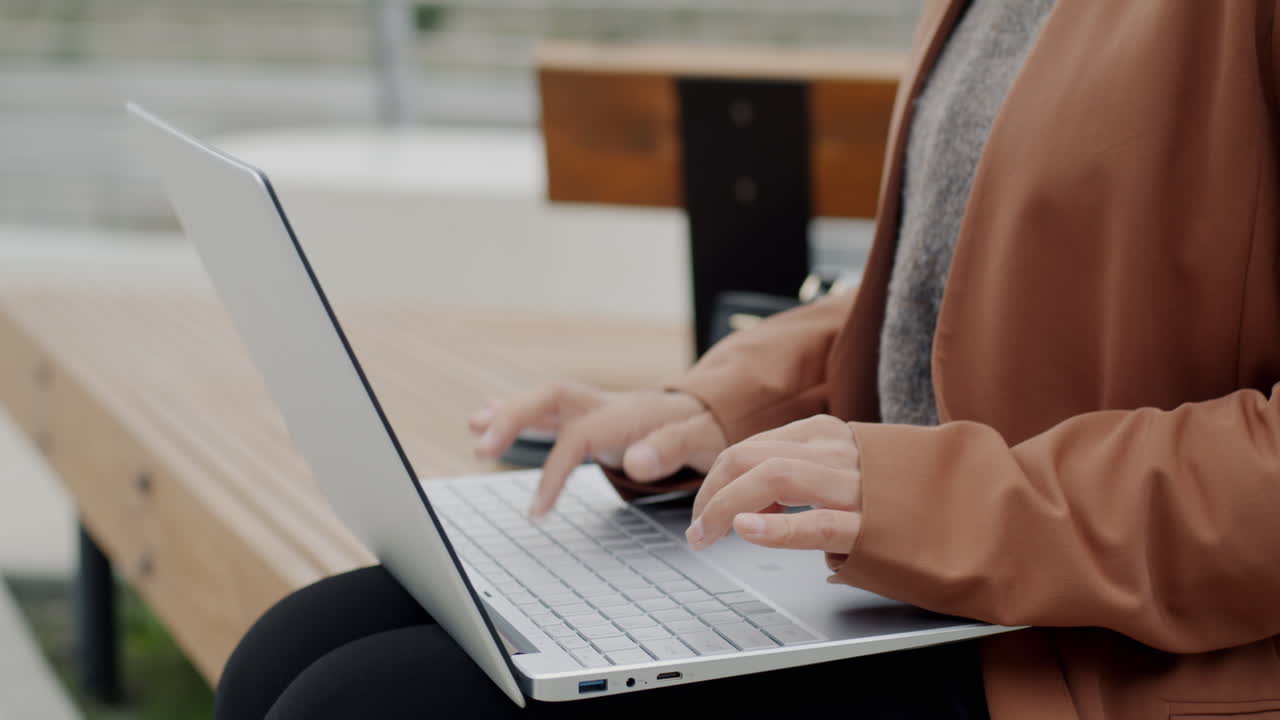 야외에서 노트북 작업을 하는 여자