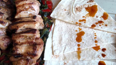 grilled chicken skewers with tortillas and hummus
