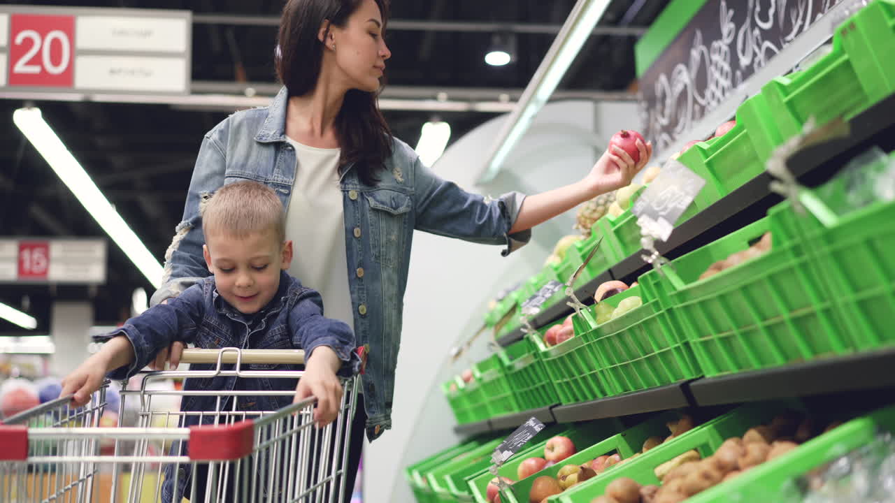 Mother and Child Shopping for Fruits at Supermarket
