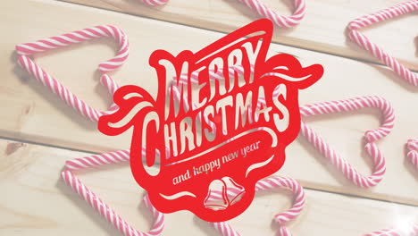 animation of merry christmas and happy new year text over candies on wooden background