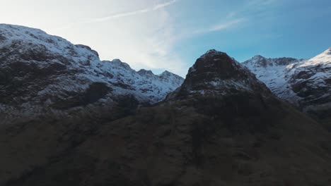 slow panning shot revealing the mountain range at the 3 sister of glencoe