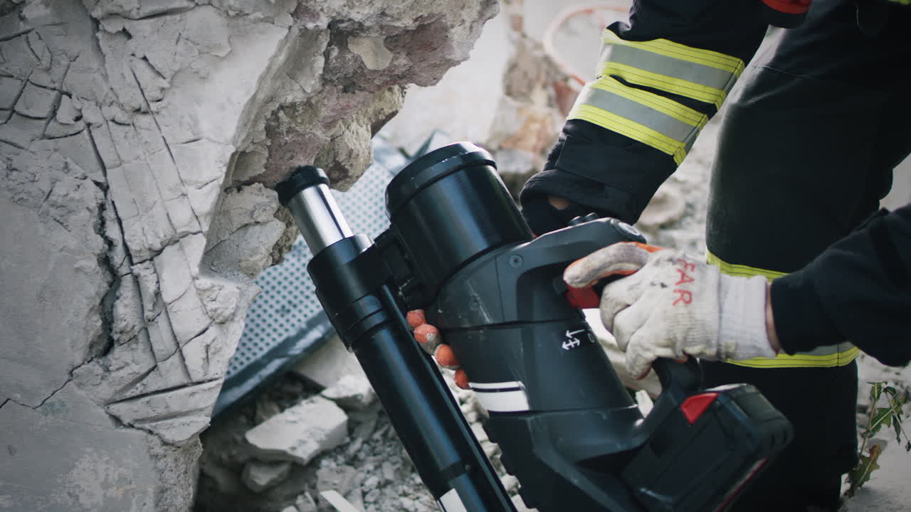 Firefighter using hydraulic ram to rescue victims from a collapsed building