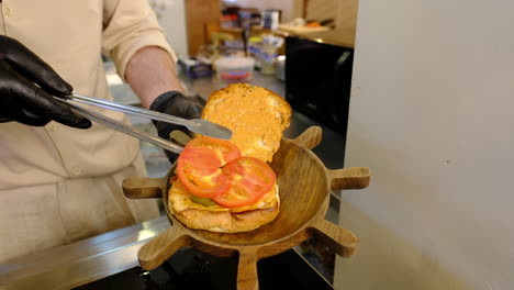 building the perfect burger: fresh tomatoes on a toasted bun