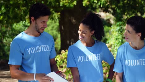 Volunteers-discussing-with-each-other-in-park-4k