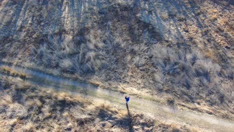 mature man on a hiking trail is lost and confused - aerial view