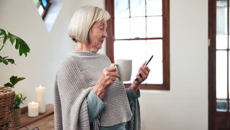 Home,-smartphone-and-senior-woman-with-coffee