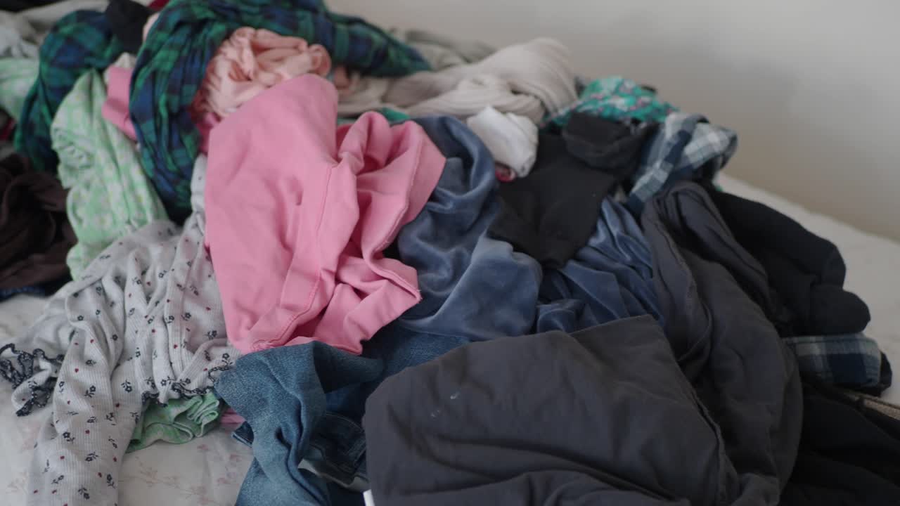 Pile of Dirty Clothes on a Bed