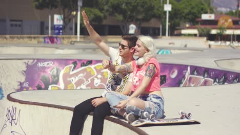 happy trendy young couple waving at someone