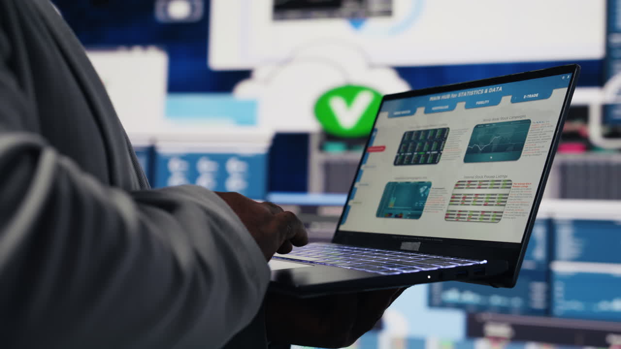 Black business manager using his laptop to examine fintech insight