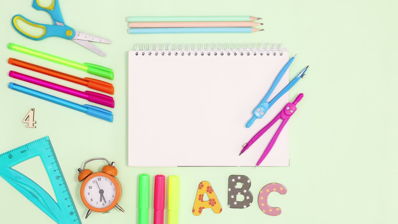 Back to school writing stationery appear around notebook. Stop motion
