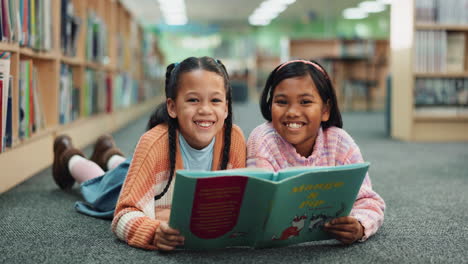 two young girls reading in a library