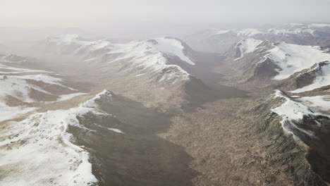 large-snow-patch-left-over-on-the-volcanic-rock-field-of-a-mountain-in-summer