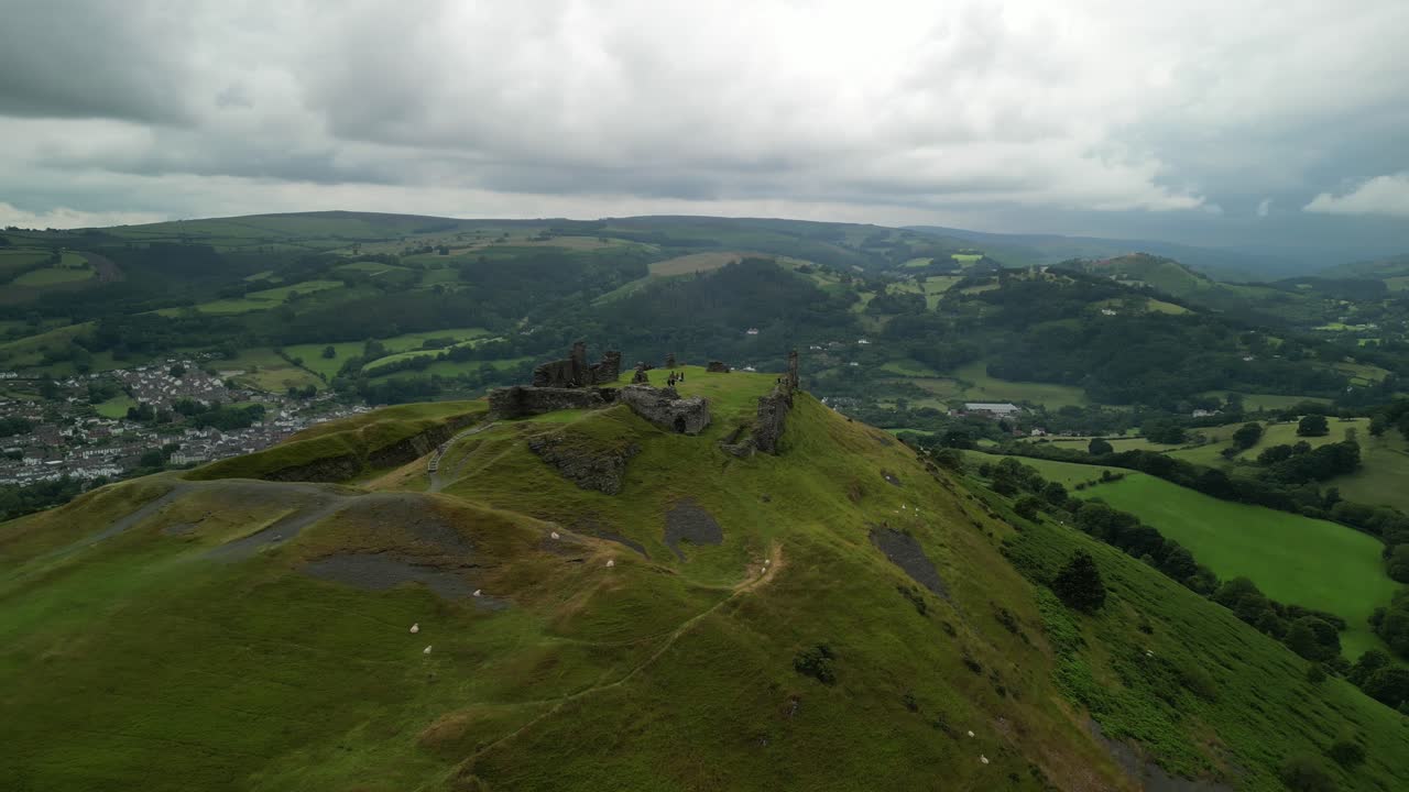 Aerial view of castle ruins on a green hill