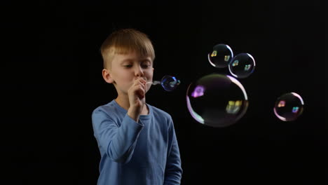 boy blowing soap bubbles
