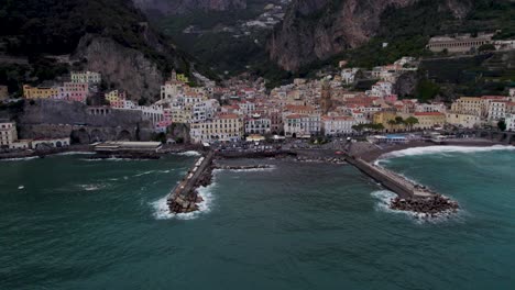 Aerial-reveal-of-gorgeous-coastal-town-in-rugged-cliffside-setting,-Amalfi