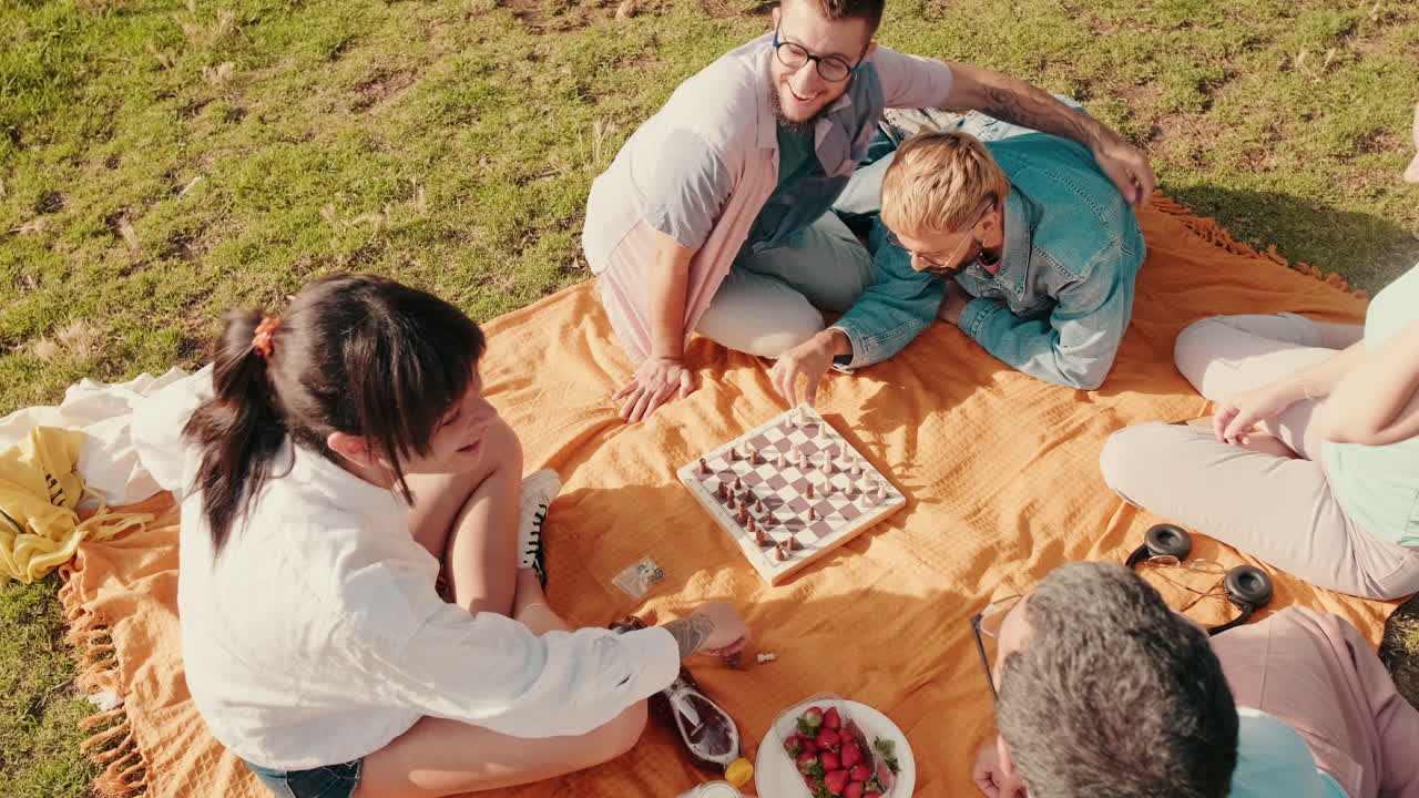 Friends Playing Chess at a Picnic