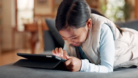 sofa, tablet and happy kid in home living room