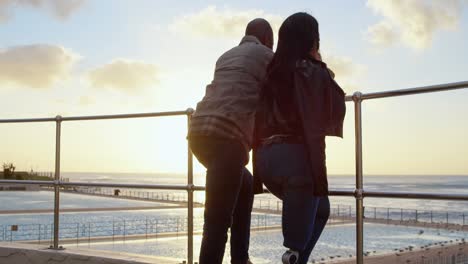 couple standing near railing on a sunny day 4k