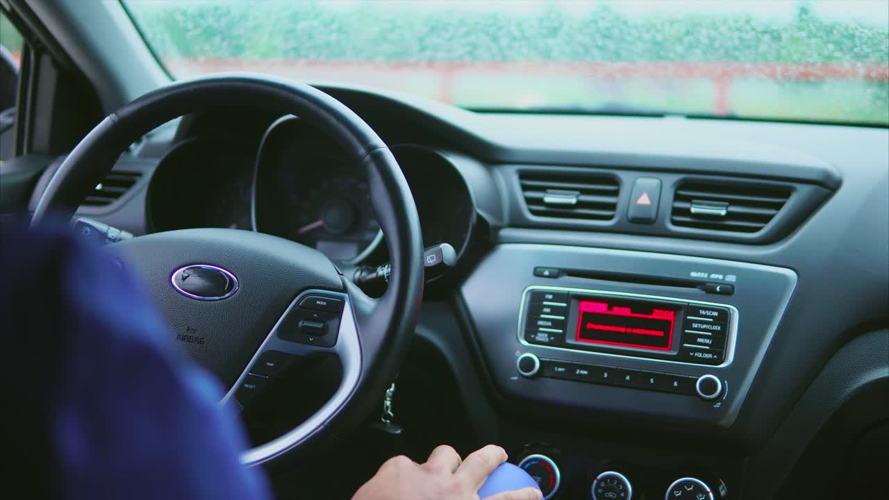Person Driving a Car on a Rainy Day