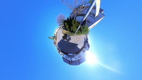 little tiny planet 360 small world view of a man walking on street near signs in 4k