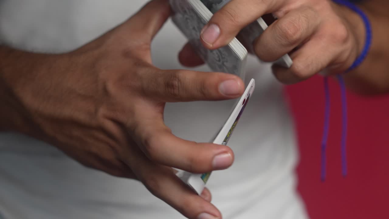 Magician showing tricks with cards and mixing the cards in slow motion