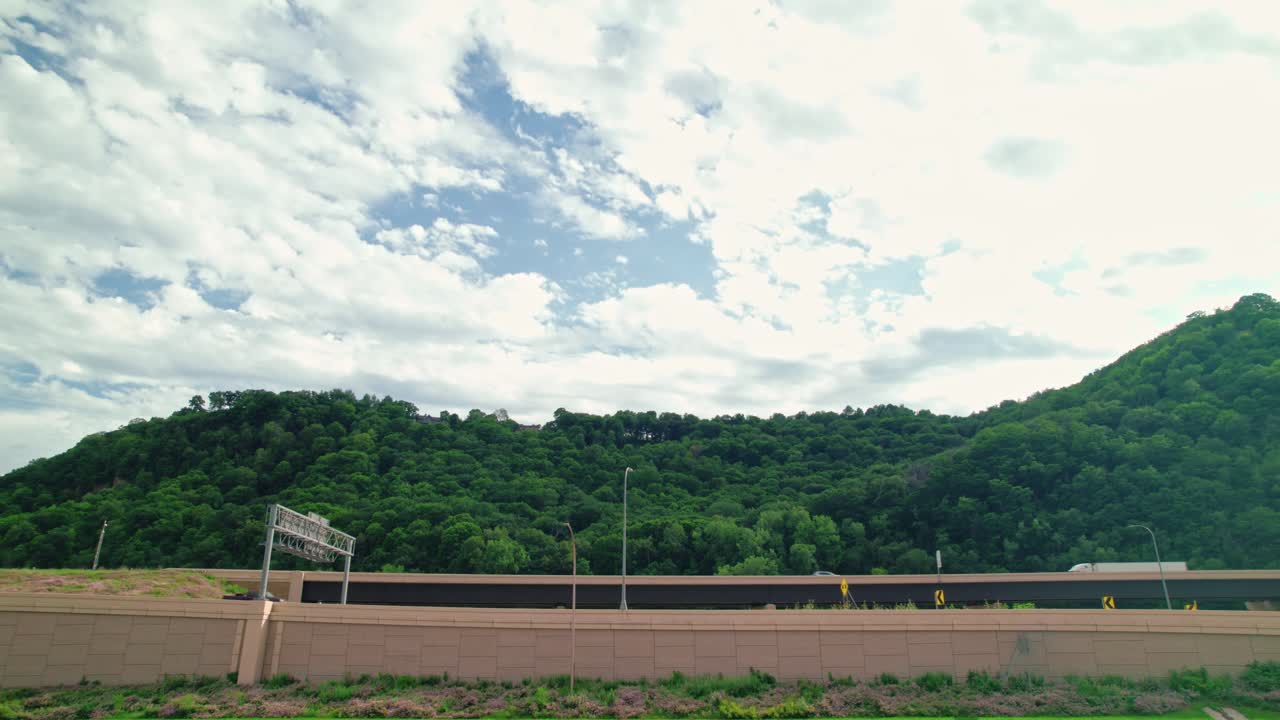 Scenic Highway Overpass with Lush Green Hills