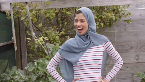 portrait of smiling biracial woman in hijab with copy space, slow motion