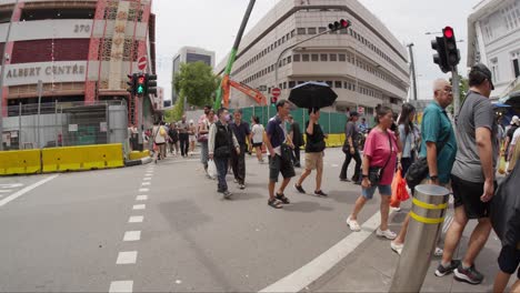 crowds of people strolling along bugis road in central singapore